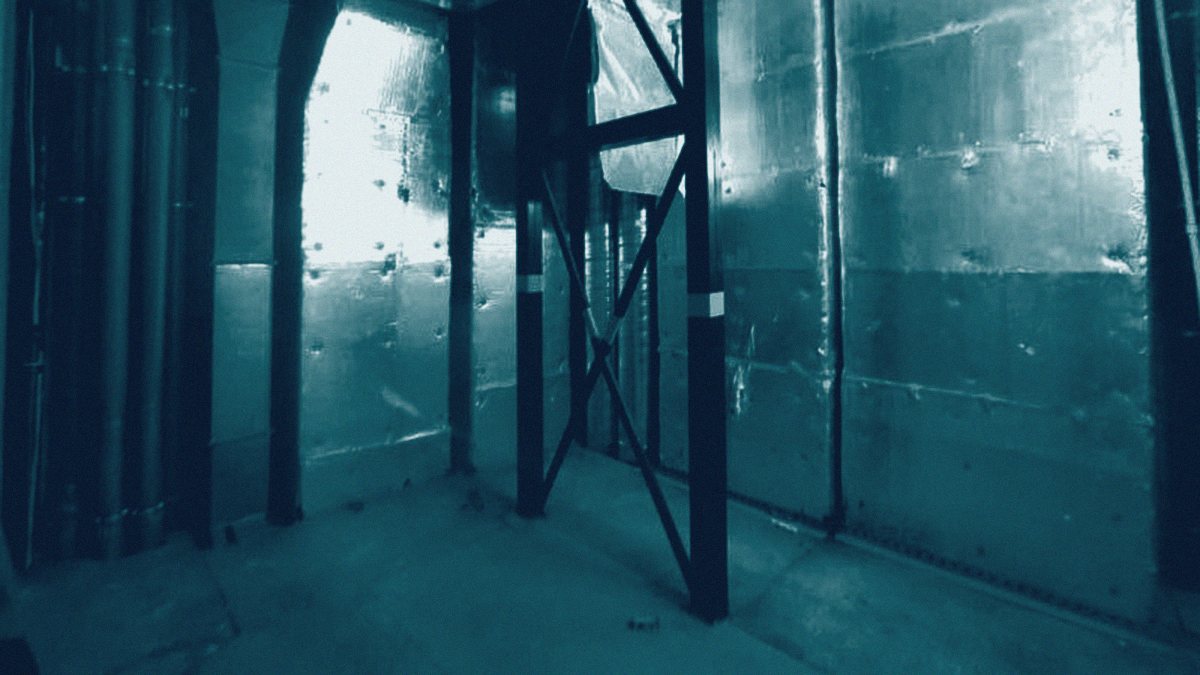 A radiation-shielded treatment room lined with steel shielding panels during construction.